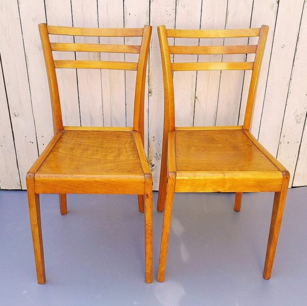 Rare paire de chaises Stella, modèle Antares G, datant des années 50. Structure et assise en bois verni.  Quelques griffures d'usage.  Très bon état Dimensions : 82 x 40 x 38 cm