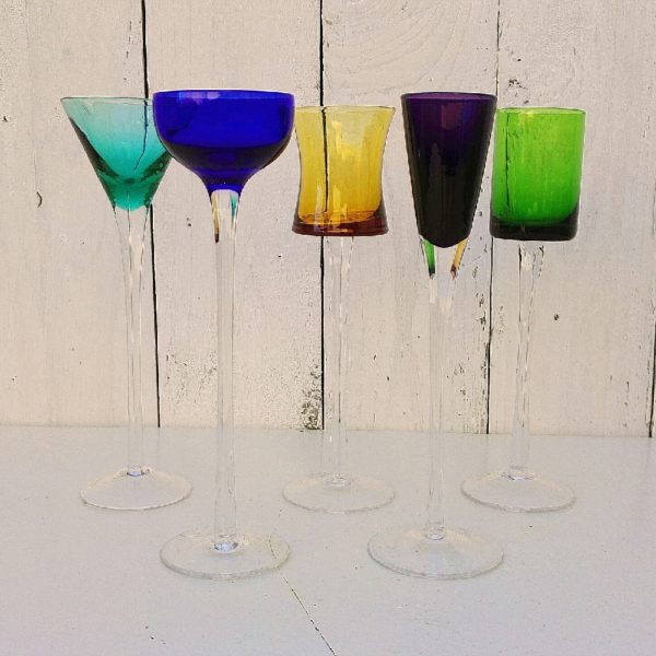 Lot de cinq verres à digestif colorés de forme différente.  Lot comprenant 1 ambré, 1 vert,1 bleu, 1 pourpre et 1 turquoise . Parfait pour une belle table de fête. Une paillette sur le verre turquoise. Bon état général. Hauteur : 18 cm