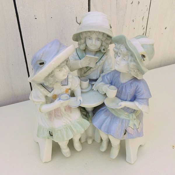 Statuette animée en porcelaine de Saxe, représentant un groupe de trois fillettes prenant le thé. Les têtes dodelinent et jambes se balancent. Un bras a été cassé et recollé. Bon état général. Dimensions : 14 x 10 cm Hauteur : 16 cm