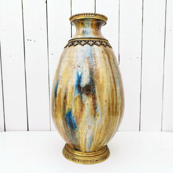 Grand vase balustre en grès flammé datant du XIXème, esprit Napoléon III, orné de frise en bronze doré. Manque de dorures sur certains endroits. Très bon état. Hauteur : 42 cm Circonférence max : 72 cm