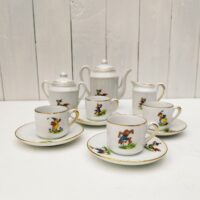  Service à café en porcelaine, dînette pour enfant. Composé d'une cafetière; d'un sucrier, d'un pot à lait et de quatre tasses + soucoupes. Décor d' animaux. Liseré doré. Une micro égrenure sur le rebord de deux tasses et sur l'intérieur d'un couvercle Bon état général Hauteur cafetière avec couvercle : 12,5 cm