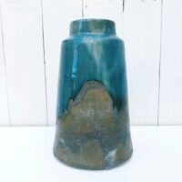 Vase en grès vernissé et émaillé. Des teintes de bleues  Signé Pierre Pigaglio. Excellent état. Hauteur : 24 cm Diamètre : 7,5 cm
