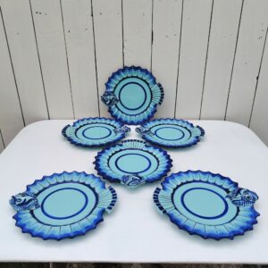 Six assiettes à poissons représentant certainement une sole , en faïence de Quimper, Signée Henriot, Quimper VL pour Victor Lucas. Assiettes datant des années 60-70. Idéales pour servir, poissons, crustacés,coquilages. Modèle très peu commun. Petites égrenures sur le bout de la bouche d'une assiette, traces de pernettes* en dessous. Bon état général. Diamètre : 21,5 cm *Pernettes : Une pernette est un support qui permet d'éviter que les poteries ne se touchent dans le four durant la cuisson. Ce qui laisse des endroit sans émail sur le dessous des céramiques.