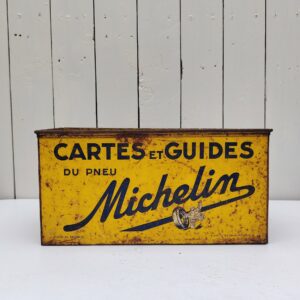 Ancienne boite en métal peint , publicitaire pour la marque Michelin. Elle servait à ranger les cartes et les guides michelin. Traces de corrosion, des rayures d'usage, manque de peinture.  Bel état pour une boite de son age. Dimensions : 33 x 14,5 x 17 cm