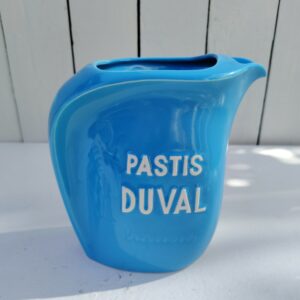 Pichet en céramique bleue publicitaire pour la marque d'anis Duval. Cigale en relief sur le coté de l'anse. Excellent état. Hauteur : 16,5 cm