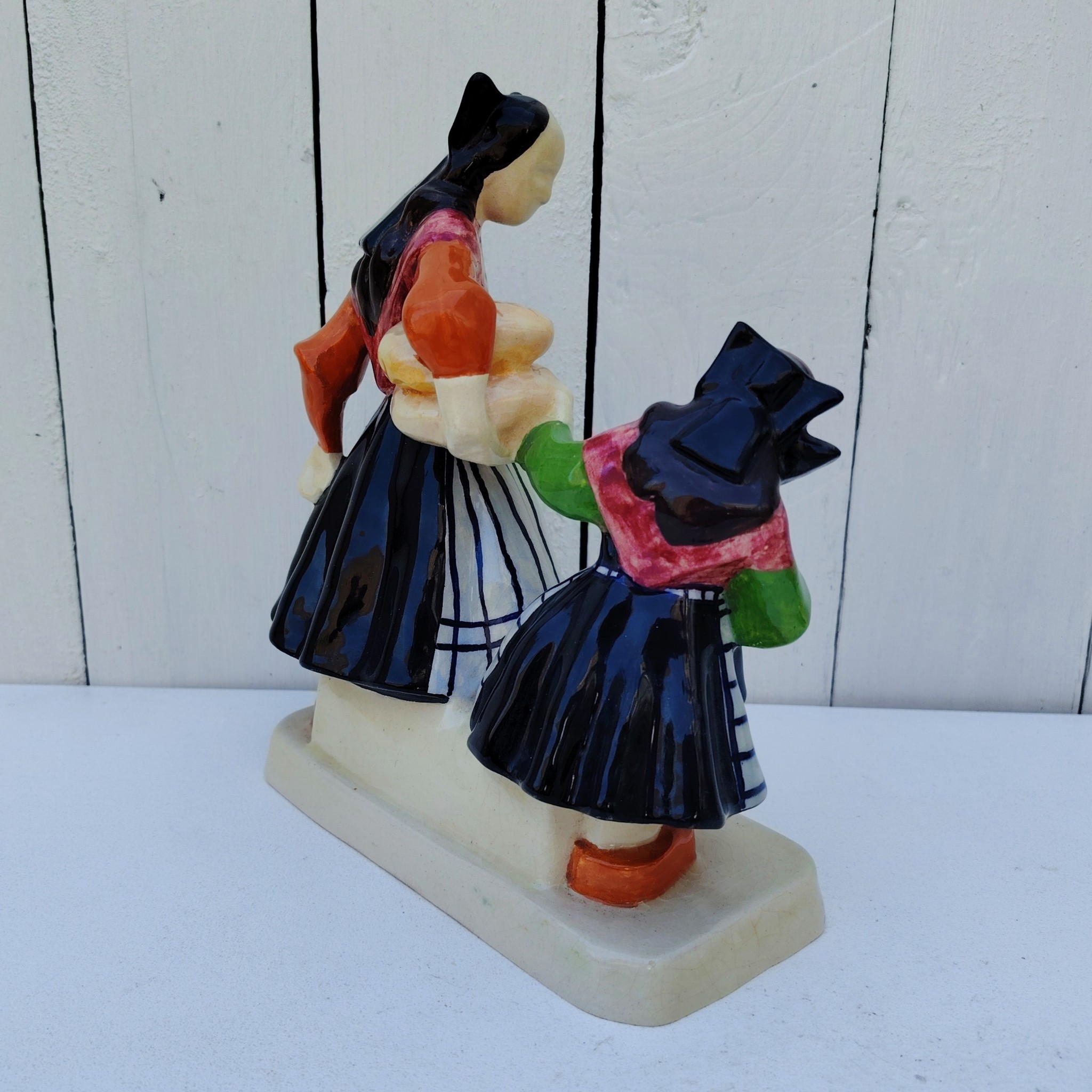 Personnages en céramique de Quimper, de la manufactures Henriot, représentant les Ouessantines aux miches de pain crées par Micheau Vernez dans les années 30. Céramique signée sur le dessous. Très bon état. Hauteur : 22,5 cm Dimensions terrasse : 17 x 8 cm