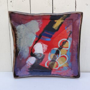 Vide poche en céramique créé par Eduardo Constantino, décor abstrait dans les tons rouge-bleu et doré. Signature en creux sous la base. Décor abstrait. Excellent état. Dimensions : 25 x 26 cm