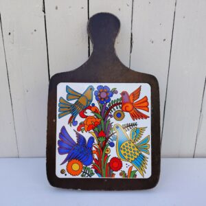 Grand dessous plat en forme de planche à découper en porcelaine Villeroy & Boch modèle Acapulco. Contour bois traces d'usage. Un féle au milieu du carreau Bon état. Dimensions : 37 x 23,5 cm