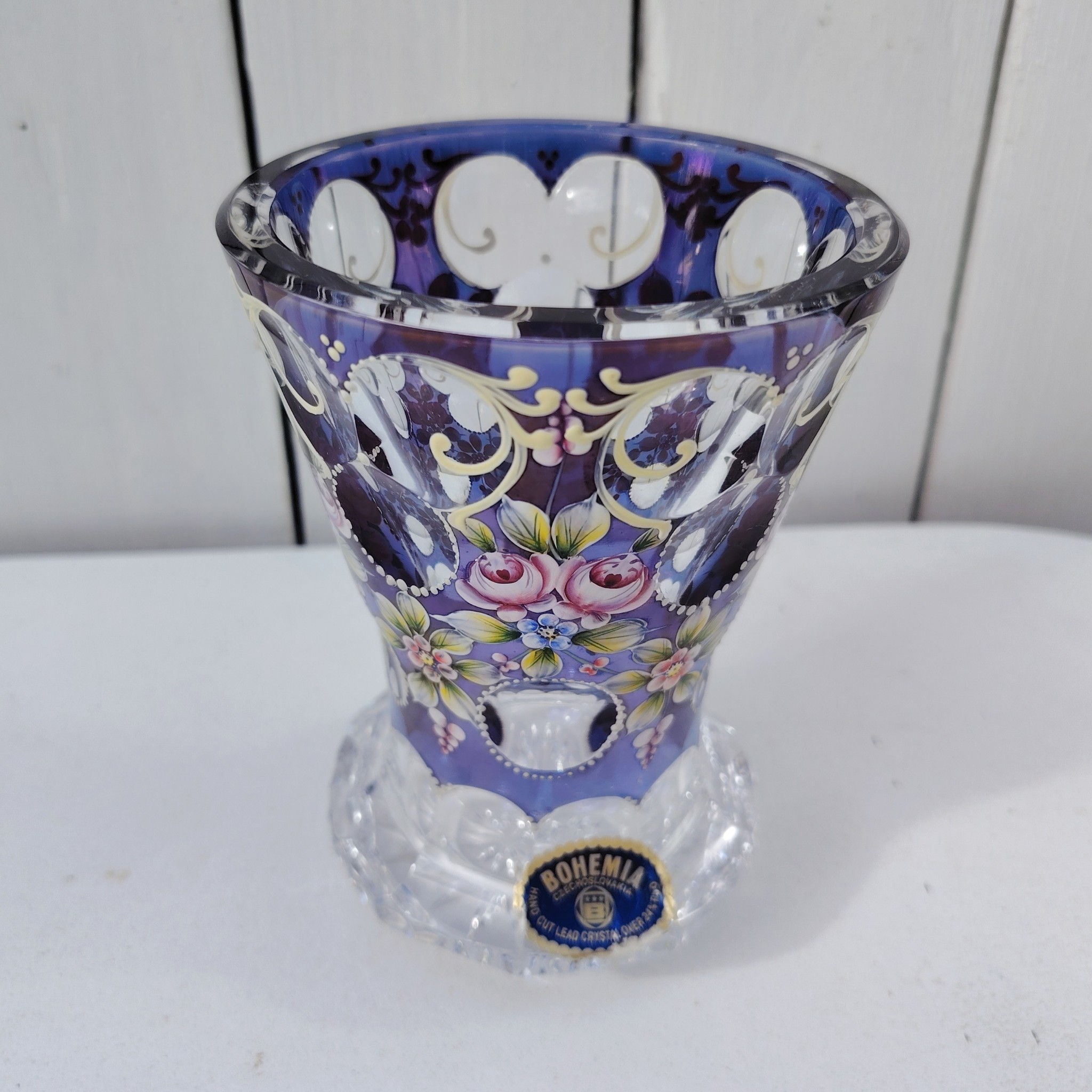 Petit vase en cristal de Bohème à décor floral peint rehaussé de points émaillés en relief. Etiquette d'origine sur le vase. Excellent état  Hauteur : 14 cm Diamètre : 9,5 cm