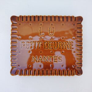 Dessous de plat publicitaire de la marque Lu pour les petits-beurre, à la forme mythique du biscuit. Excellent état. Dimensions : 25 x 21,5 cm