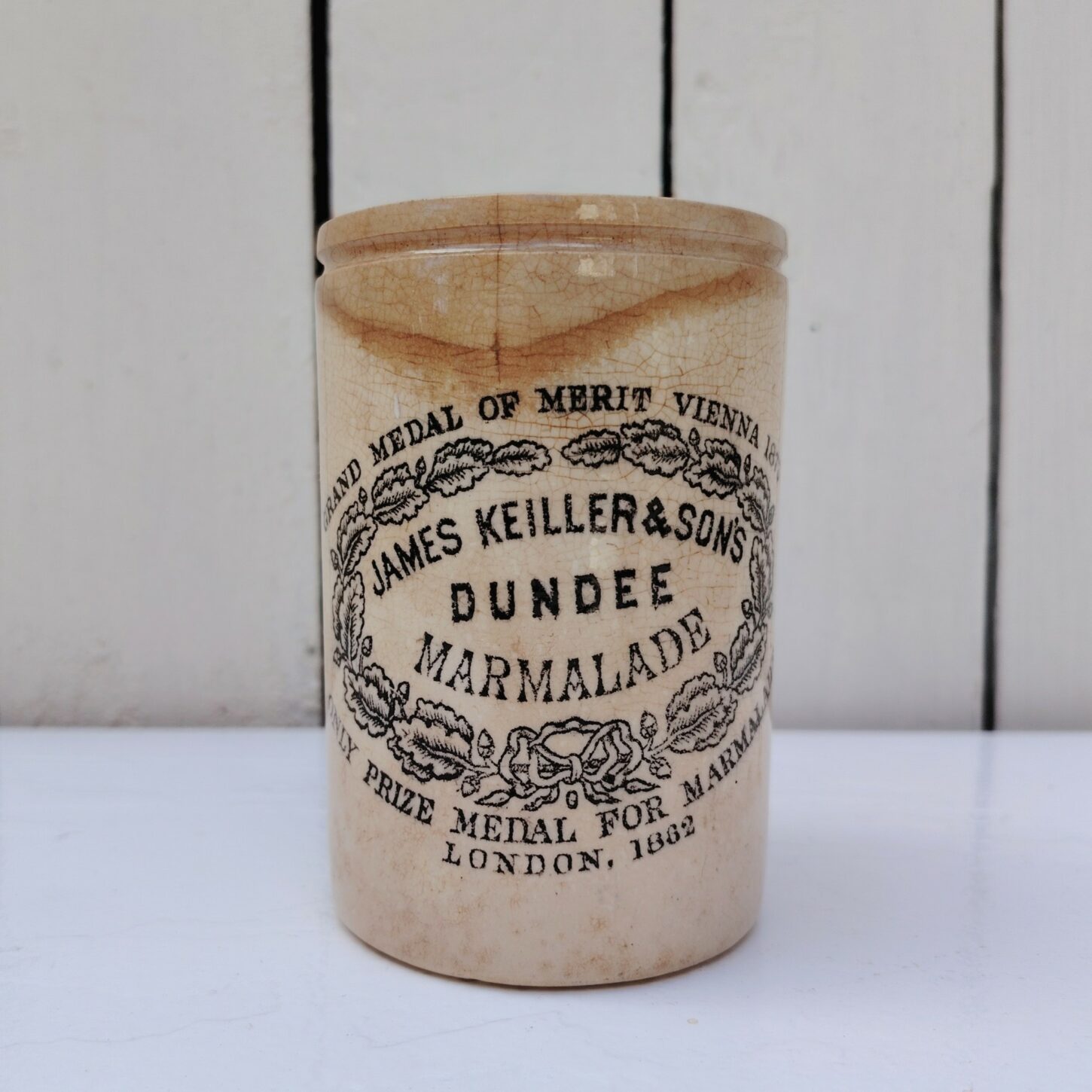 Ancien pot de marmelade Dundee de la marque James keiller & sons, en céramique anglaise. Céramique craquelée, jaunissure et brunissement du pot. 2 fèles sur le haut. Hauteur : 11,5 cm Diamètre : 7,5 cm